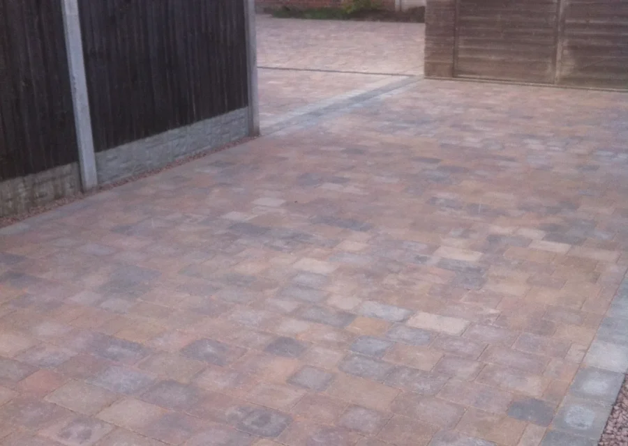 Block paved driveway running down the side access of a semi detached house